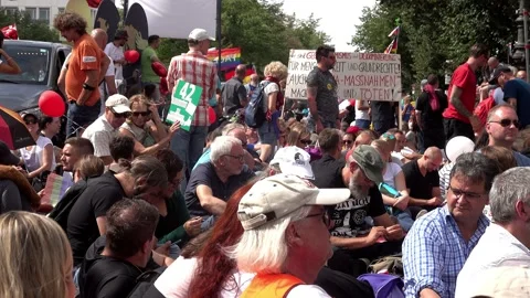 Demonstrators sit in the streets during the Anticorona demonstration Stock Footage 138383816