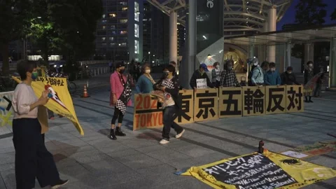 Demonstrators stage a protest against the 2020 Tokyo Olympics - 4K Stock Footage 154898832