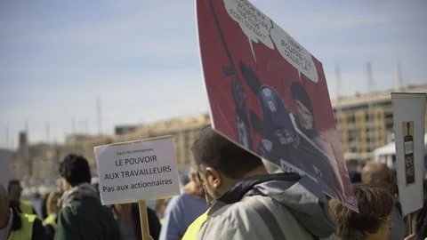 Demonstrators talking while holding signs at Gilets Jaunes protest, Vieux Port Stock Footage 104538803