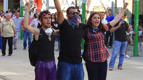 Demonstrators wave flags and shout slogans during a protest on Istiklal Street Stock Footage 49643765
