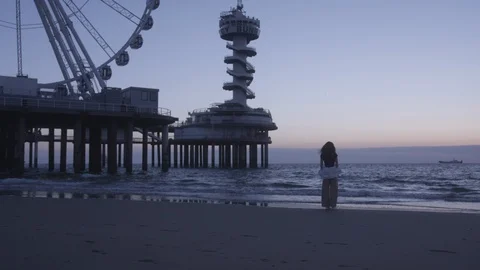 Den Haag Beach Package 9 | woman alone standing on beach thinking life Stock Footage 116191900
