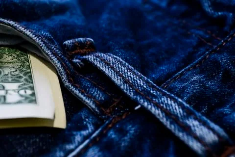 Denim clothes lying on the table with the glasses. Blue jeans wi Stock Photos