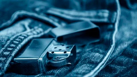 Denim clothes lying on the table with the glasses. Blue jeans Stock Photos