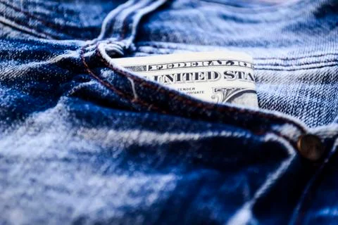 Denim clothes lying on the table with the glasses. Blue jeans Stock Photos