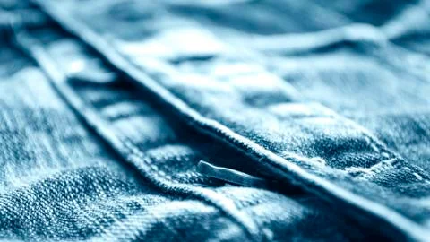 Denim clothes lying on the table with the glasses. Blue jeans Stock Photos