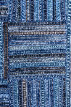 Denim fabric pattern in patchwork style. Stock Photos