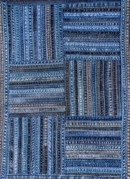 Denim fabric pattern in patchwork style. Stock Photos