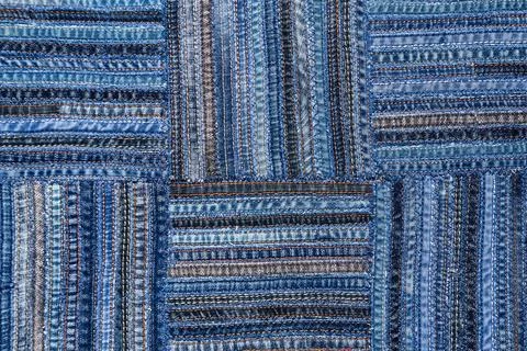 Denim fabric pattern in patchwork style. Stock Photos