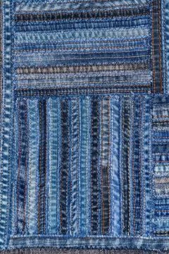 Denim fabric pattern in patchwork style. Stock Photos