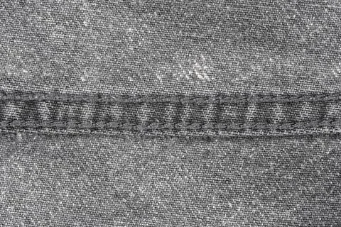 Denim fabric texture with visible stitching and cotton weave pattern Stock Photos
