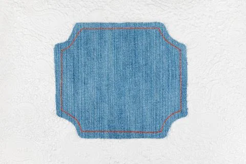 Denim frame lies on a white with pattern skin 写真素材