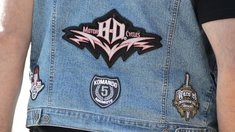 Denim jacket of a biker with different patches Vídeos de archivo 89985350