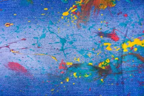 Denim, jeans texture background. Drops of colorful paint on blue background d Stock Photos