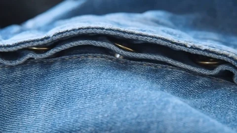 Denim pants. Metal buttons, texture of fabric and seams with coarse threads Stock Footage 106604262