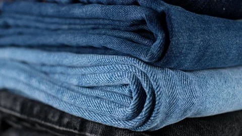 Denim. stack of folded jeans blue, black, light blue, close up Stock-Footage 149976605