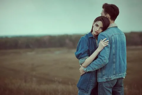 Denim style. Dramatic couple of young people in denim clothes standing in a v Fotos Stock