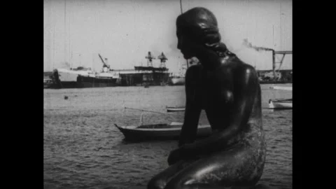 DENMARK 1940s: Man uses film camera, looking up at building. Plaque on side of Stock Footage 253354784