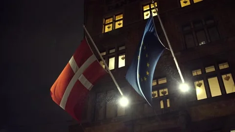Denmark and European Union flag at night in rain in December Stock Footage