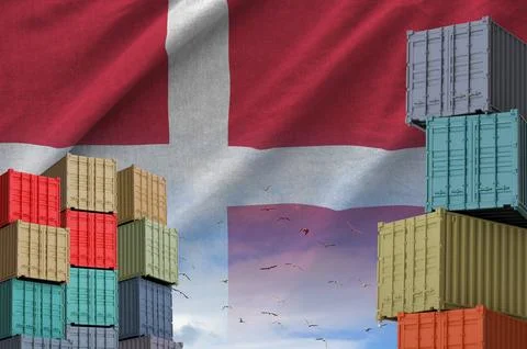Denmark flag and big stack of shipping cargo containers in docks with sky Stock Photos