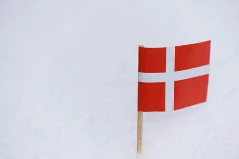 Denmark flag made from paper with brown toothpick on white snow background. Stock Photos