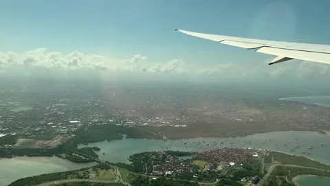 Denpasar, Bali: Looking out the window of an aeroplane after takeoff, 4k Stock Footage 254342343