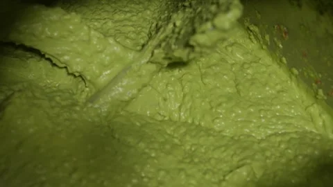Dense Avocado Paste Filling Frame During Food Processing Stage Stock Footage 334697980
