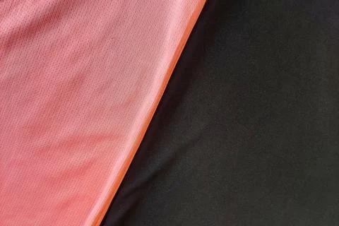 A dense backdrop texture of a pink salmon mesh polyester fabric placed diag.. Stock Photos