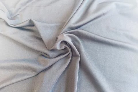 A dense background backdrop texture of smooth silver gray spandex nylon fab.. Stock Photos