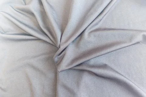 A dense background backdrop texture of smooth silver gray spandex nylon fab.. Stock Photos