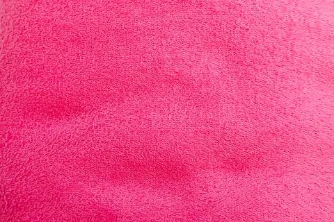A dense background backdrop texture of soft bright magenta pink fuchsia cot.. Stock Photos