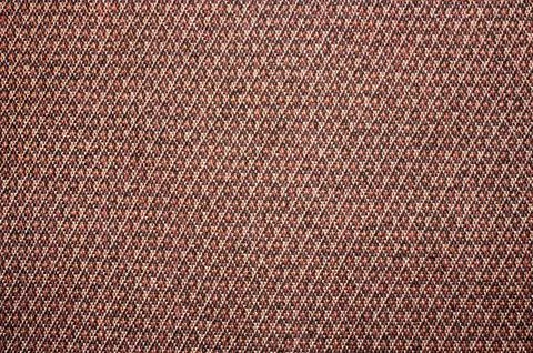 Dense brick-colored diamond-shaped texture.Diamond-and-speckled fabric. Stock Photos