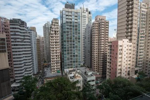 Dense building with tree in between highrise in Sai Ying Pun Stock Photos