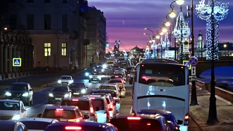 Dense city traffic in twilight winter time along the Neva river Stock Footage 169035686