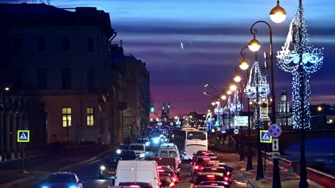 Dense city traffic in twilight winter time along the Neva river Stock Footage 169035836