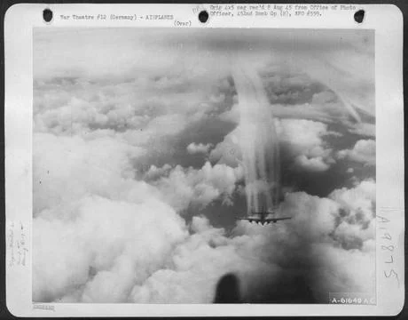 With Dense Cloud Formations Below It A Boeing B-17 Flying Fortress, Part O... Stock Photos