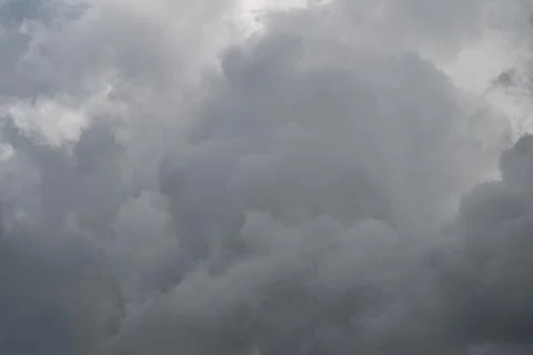 Dense cloud mass showing texture and depth, closeup view of layered gray form Stock Photos