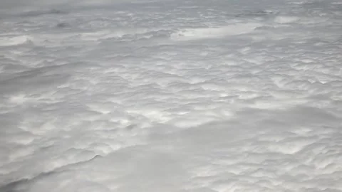 Dense cloud sea from plane window - Atmospheric Layers and Layered Atmosphere Stock Footage 339726531
