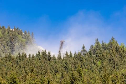 A dense cloud of white dust from an industrial conveyor belt of a stone quarry Stock Photos