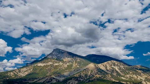 Dense clouds above a mountain top time lapse scene Stock Footage 281653698