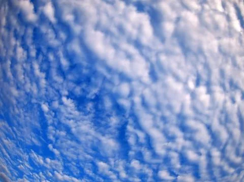 Dense clouds on a bright blue sky Stock Photos