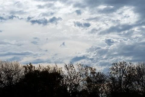 Dense clouds drift across a vast, moody sky 库存照片