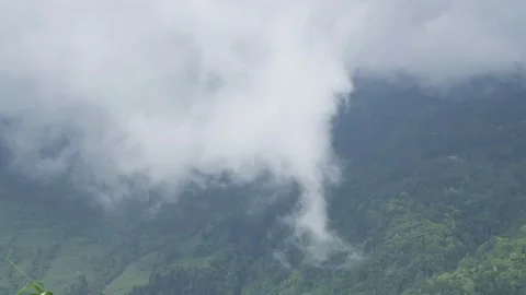 Dense clouds moving fast over the mountains, in Dajreeling, India Stock Footage 238832289
