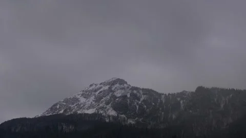 Dense clouds over the rocky peak. Windy winter weather. Slow zoom in 動画素材 152445612