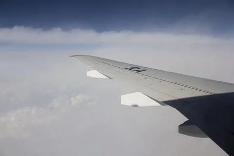 Dense clouds under the wing of an airplane. Фото