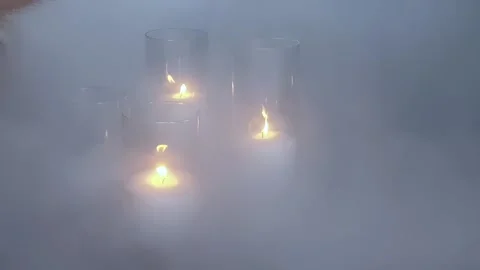 Dense clouds of white smoke envelop candles in burning vases. Stock Footage 165068720