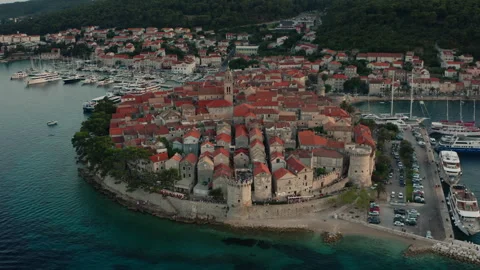 The dense cluster of red rooftops of the historic Old Town Korcula, aerial view Stock Footage 318466770