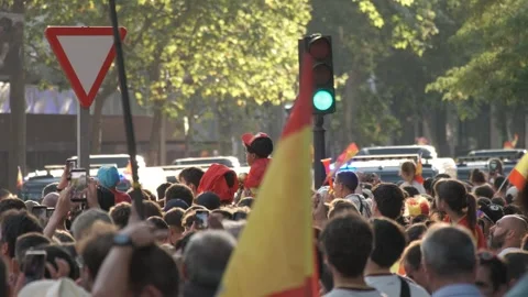 A dense crowd of Spain supporters waves national flags during celebrations for Stock Footage 340921689
