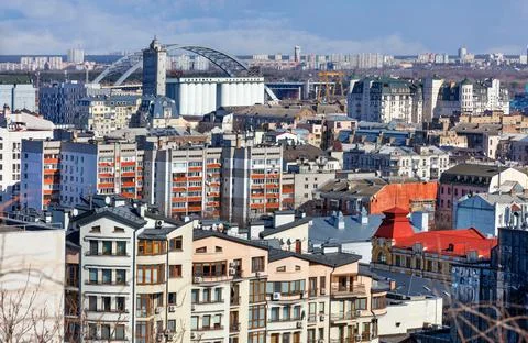 Dense development of the old district of Podil in Kyiv against the background Stock Photos