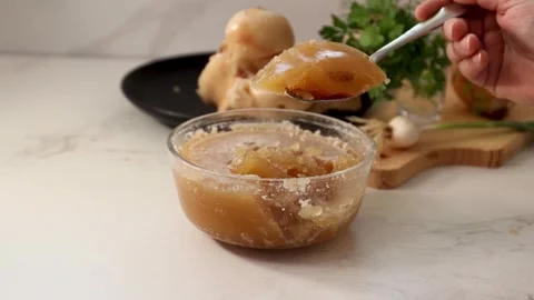 Dense, Gelatinous Bone Broth: Chilled, Collagen-Rich Texture in a Glass Bowl Stock Footage 344031634