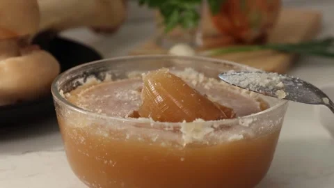Dense, Gelatinous Bone Broth: Collagen-Rich, Cooled Gel Texture in Glass Bowl Stock Footage 344031681